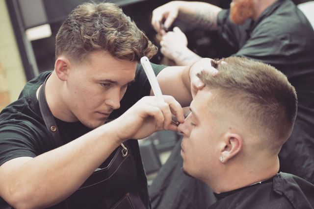 Professional barber styling hair for special occasion